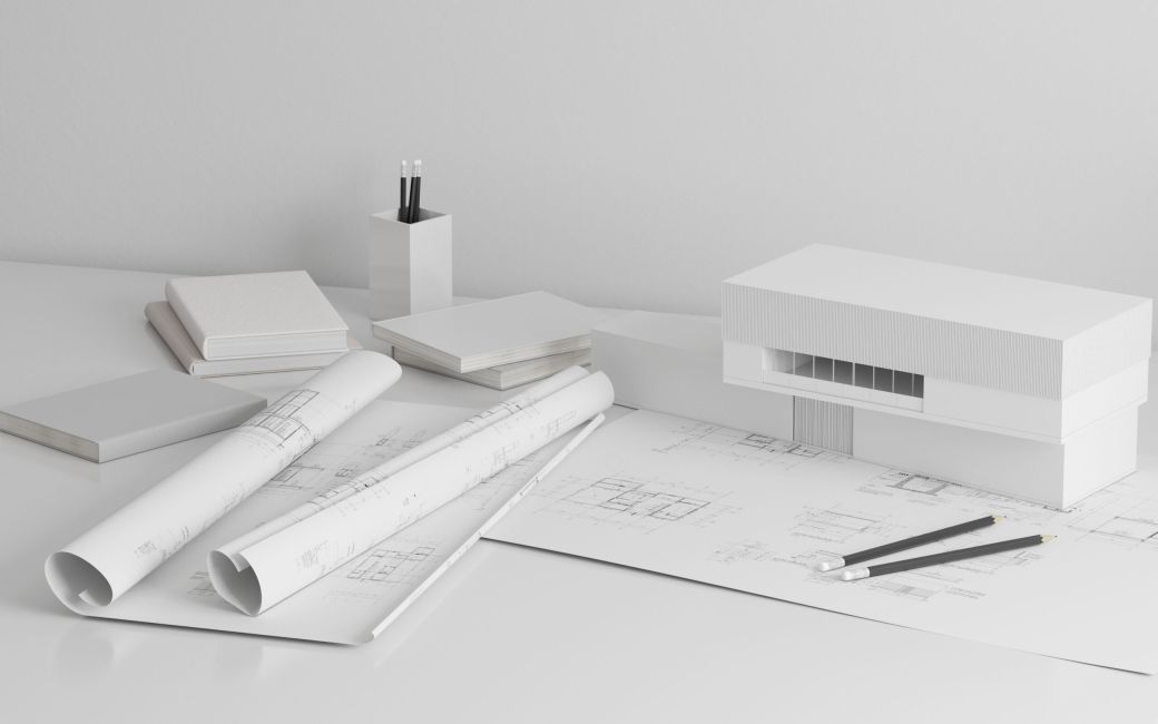 Mock-up di carta da disegno di costruzione architettonica con modello di edificio bianco, rotoli di cianografia - 3D rendering